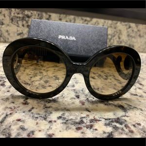 Prada oversized sunglasses with swirly side on frames.